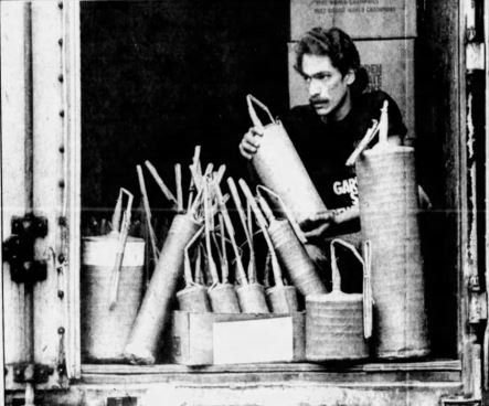 Frank Severino loading large paper shells and fuse leaders from a truck bay in a 1984 newspaper print