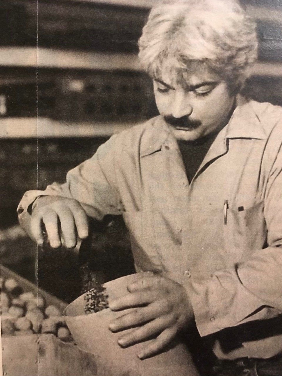 Nunzio Santore pouring black powder from a flask into a bowl while building a multi-break shell