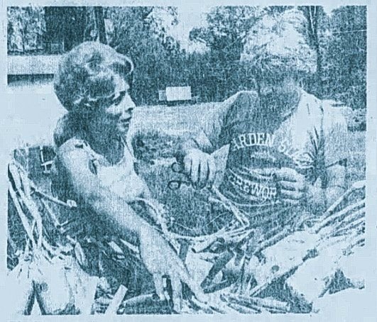 Phyllis and Nunzio Santore working outdoors on a pile of fuse sticks in a tinted newspaper print